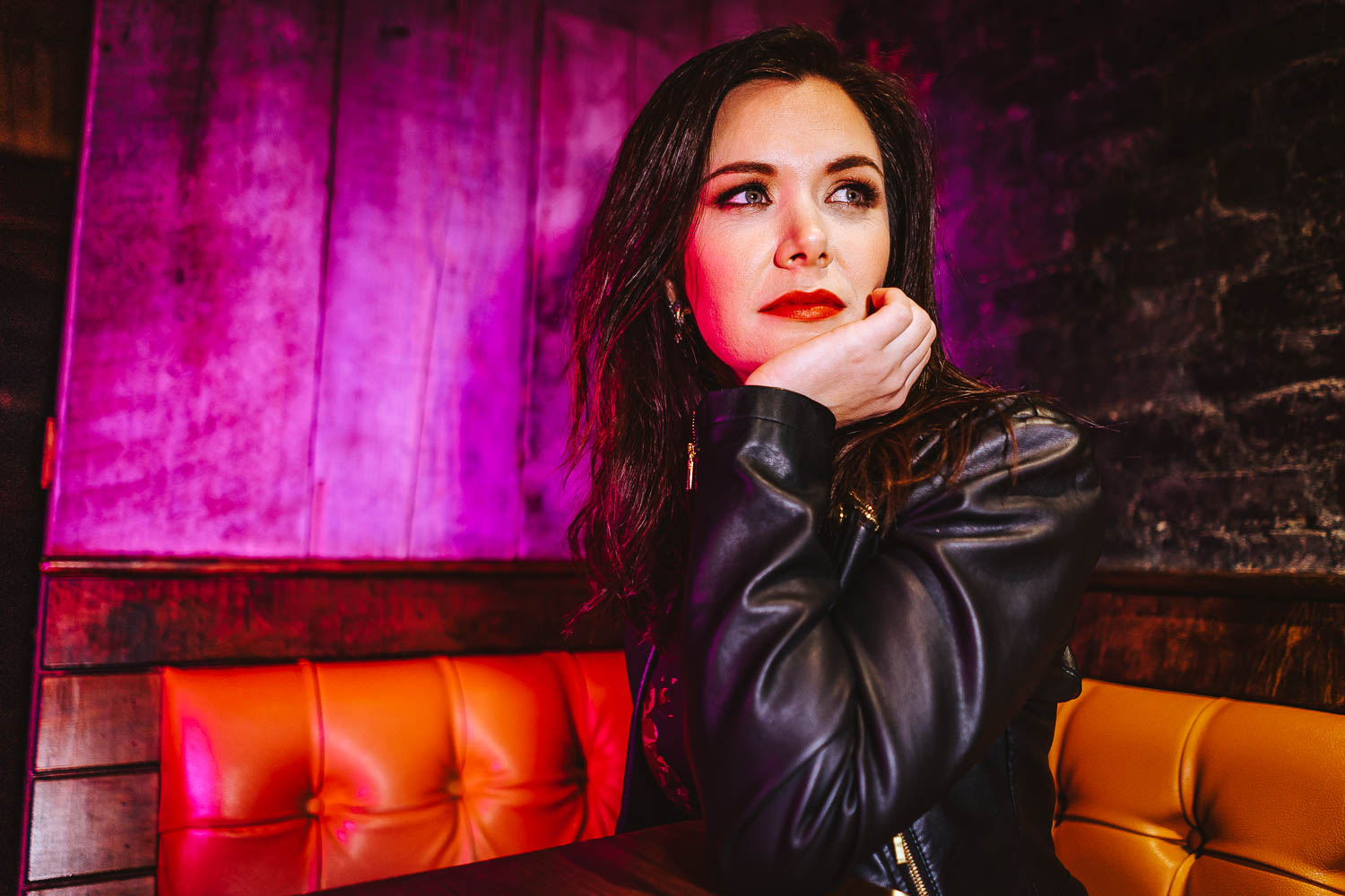 Singer-songwriter Lilah Shreeve on a bench at a bar in Astoria